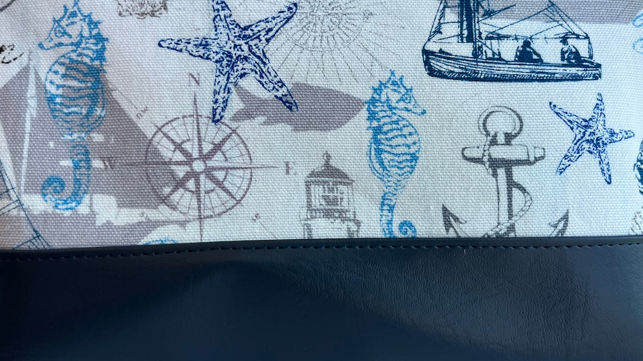 Nautical-themed fabric with seahorses, stars, and ships on a white background.