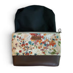Floral-patterned pouch with waterproof black interior.