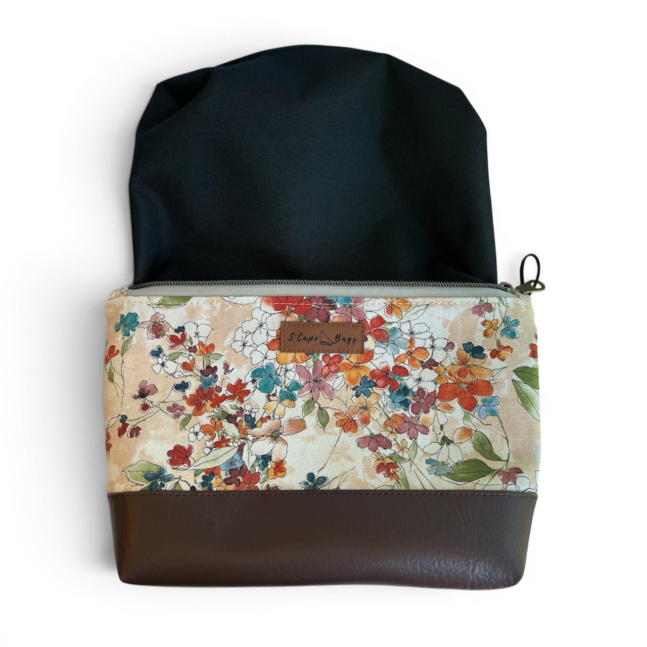 Floral-patterned pouch with waterproof black interior.