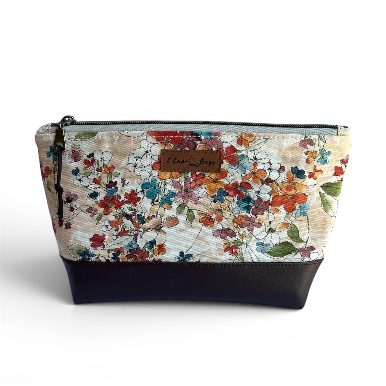 Floral-patterned pouch with dark brown base on a white background